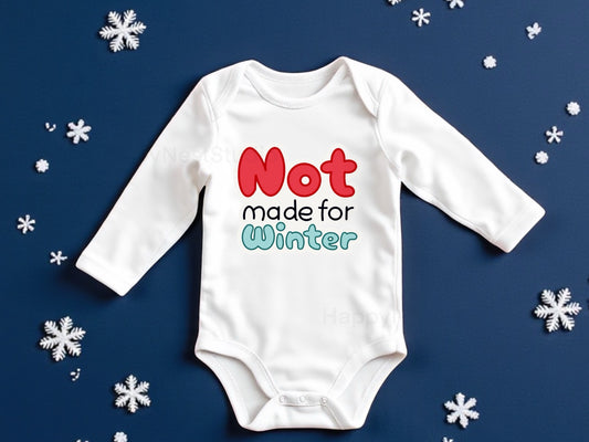 White long-sleeve baby onesie featuring a unique, shop-owner–designed sublimated printable-vinyl graphic that reads ‘not made for winter’ in bold red and icy green lettering. This handmade winter-themed baby bodysuit makes a perfect newborn gift, funny baby onesie, or cozy everyday outfit for infant boys or girls. Ideal for shoppers searching for newborn baby clothing, sublimation onesies, humorous baby gift ideas, winter baby outfits, snow-themed baby bodysuits.