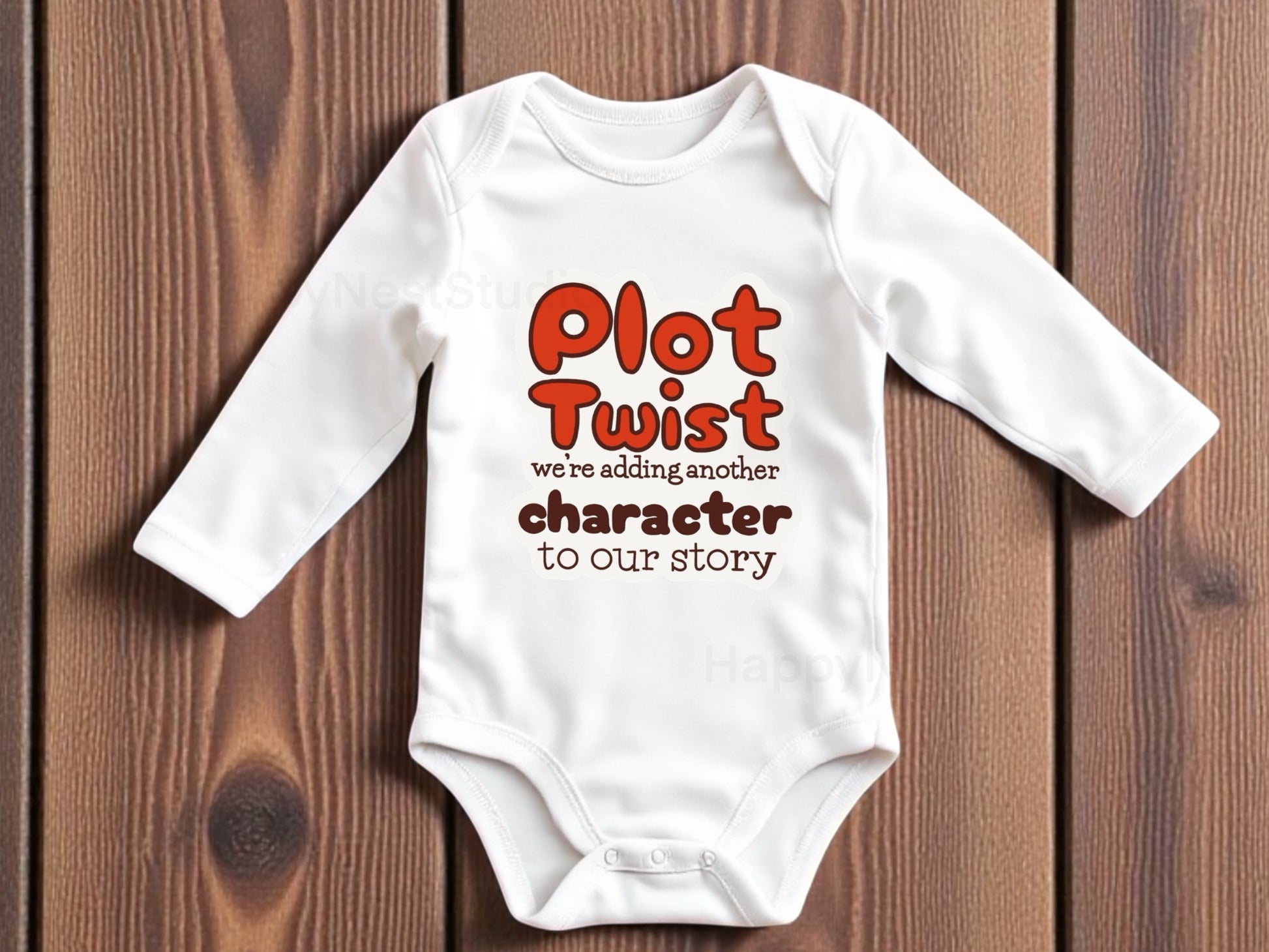 White long-sleeve baby onesie featuring a unique sublimated unisex design that says ‘Plot Twist — we’re adding another character to our story’ in playful orange and brown lettering. Displayed on a rustic wooden background, this funny pregnancy announcement baby bodysuit is perfect for surprising grandparents, family, and friends. Ideal for shoppers searching for cute baby announcement onesies, humorous pregnancy reveal outfits, new baby reveal gifts