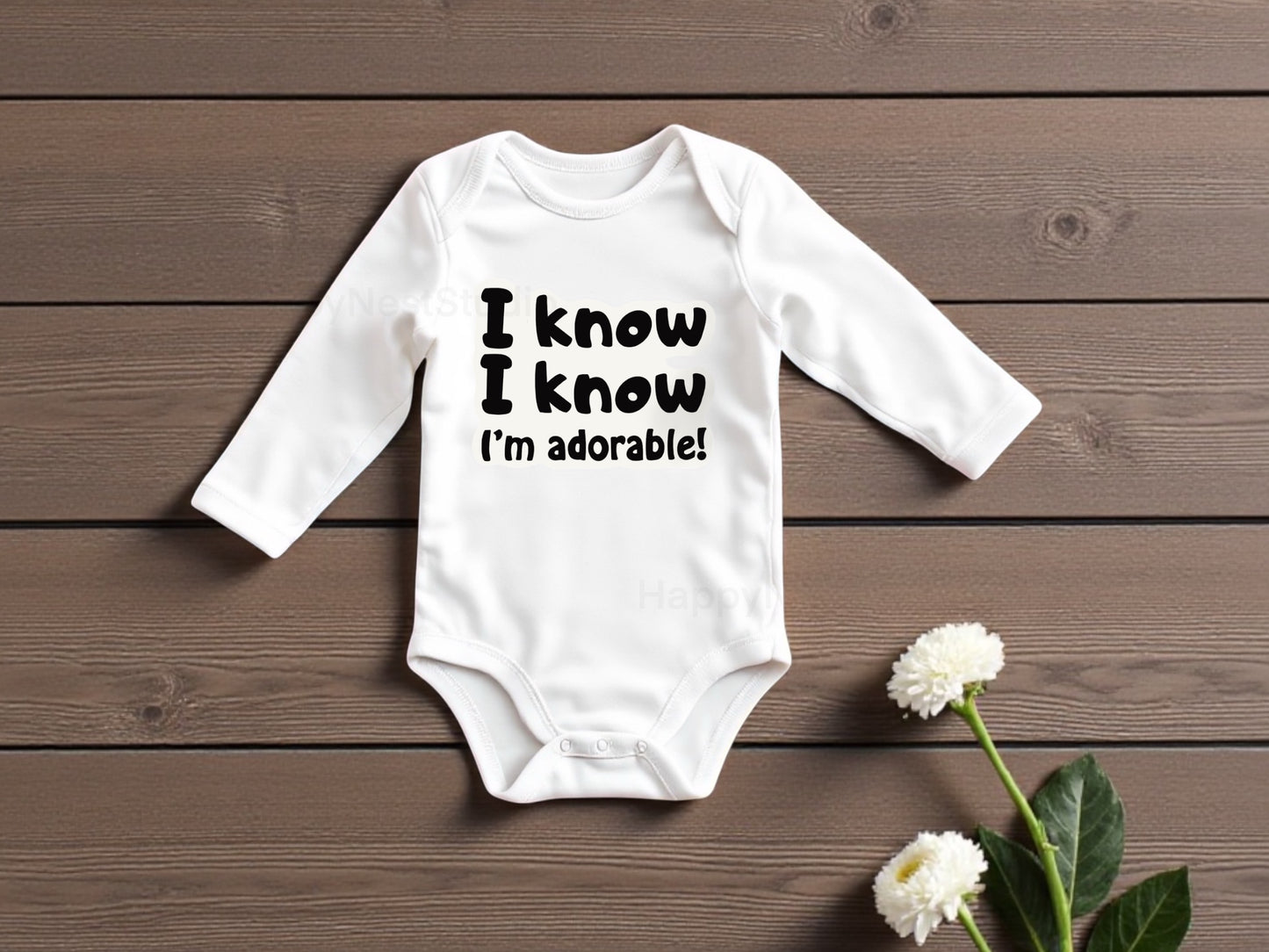 White long-sleeve baby onesie featuring a unique, sublimated printable-vinyl graphic that reads “I know I know I am adorable” in bold black lettering. the design highlights the crisp, high-quality sublimation print and modern typography. Ideal for parents and gift-givers searching for funny baby onesies, newborn baby clothing, gender-neutral infant outfits, cute baby shower gifts, custom sublimation onesies, or adorable newborn gift ideas for gifting to expecting parents.