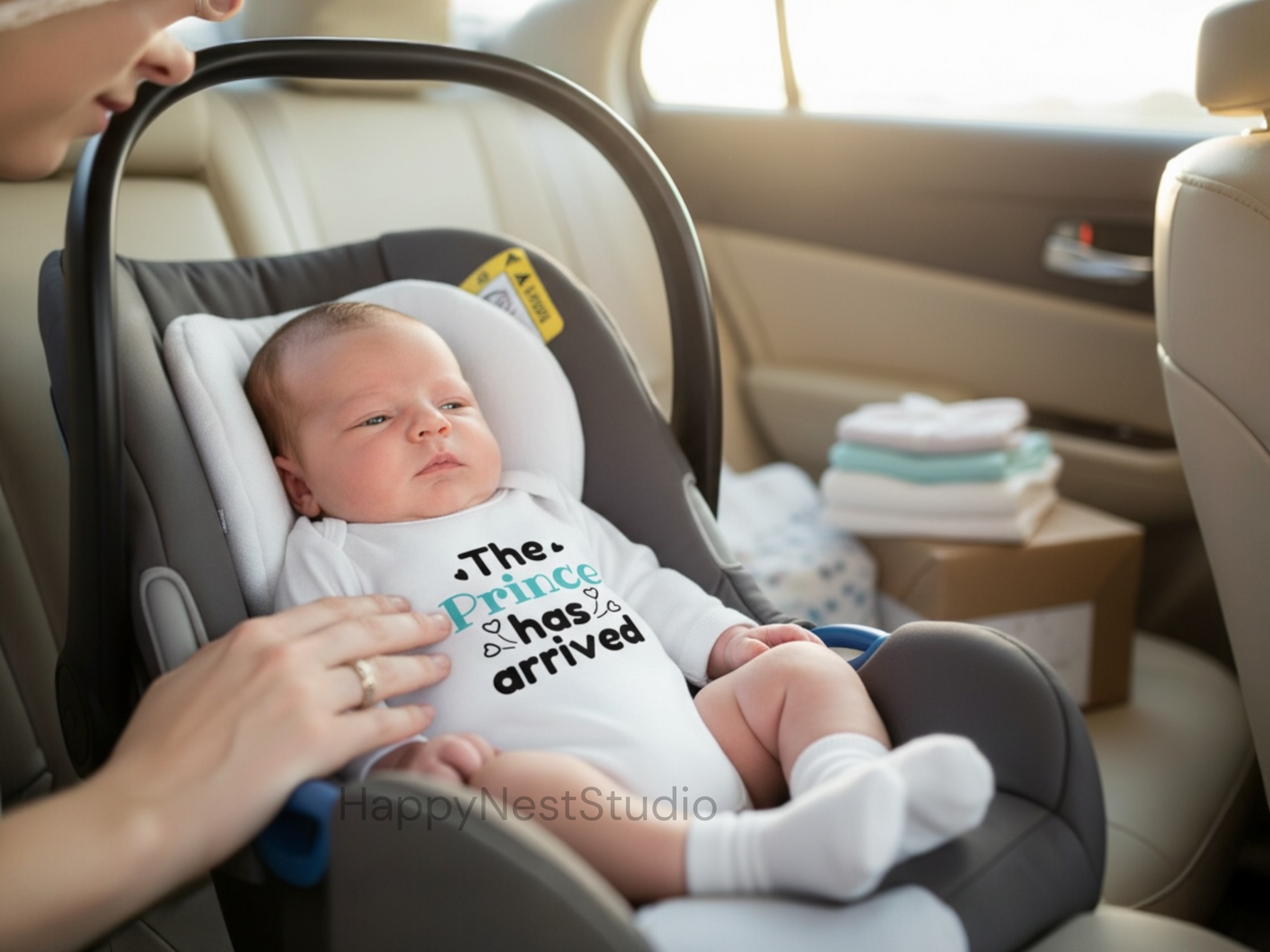 White long-sleeve baby boy onesie with a unique sublimated design that reads ‘The Prince Has Arrived’ in black and soft blue lettering, accented with small heart details. This handmade infant onesie is perfect as a birth announcement outfit, newborn photo-shoot prop, prince-themed baby clothing, or a thoughtful gift for new parents welcoming their baby boy. Ideal for shoppers searching for cute baby boy onesies, prince newborn outfits, royal baby announcement bodysuits, sublimation baby clothes.