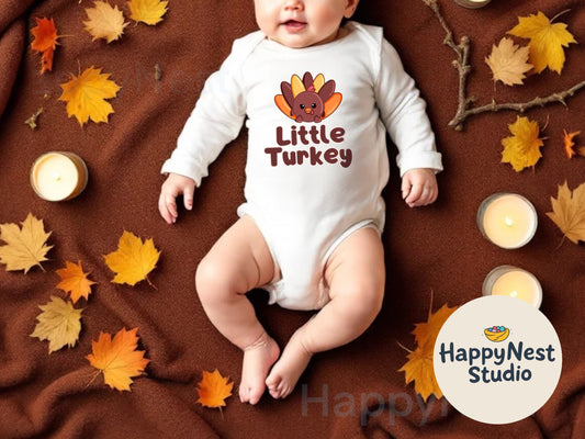 Adorable white long sleeve baby onesie featuring a cute cartoon turkey with colorful fall feathers in brown, orange, and yellow, along with the text “Little Turkey” in bold brown letters. It is perfect Thanksgiving baby outfit for newborns and infants, ideal for fall family photos, holiday gatherings, and festive baby gifts. It’s made from soft, cozy cotton for comfort and warmth. Designed by HappyNest Studio for a playful and seasonal baby look.
