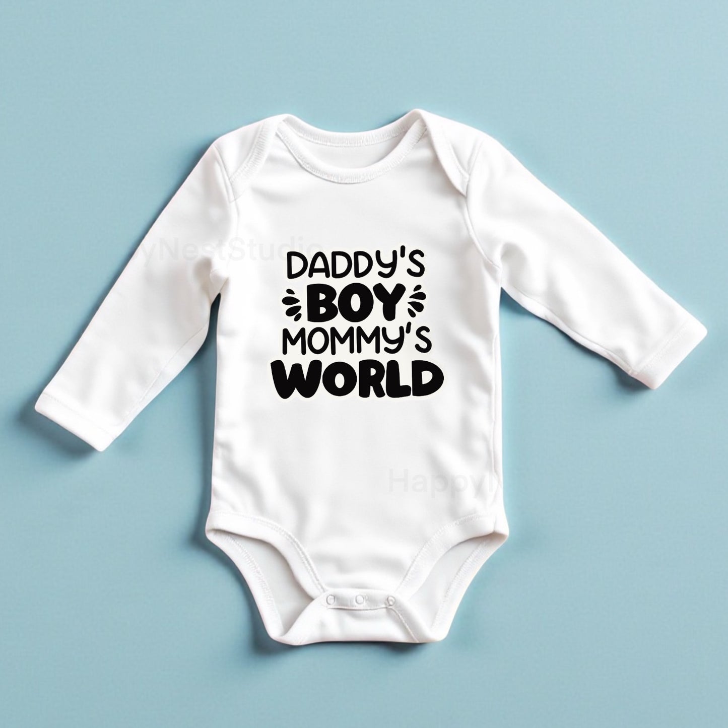 White long-sleeve baby onesie featuring a unique, originally designed sublimated printable-vinyl graphic that says ‘Daddy’s Boy, Mommy’s World’ in bold black letters. This cute baby outfit is perfect as a Christmas onesie, newborn holiday gift, baby shower present, or everyday infant boy outfit. Ideal for shoppers searching for handmade baby clothing, custom sublimation onesies, unique newborn gifts, personalized infant apparel, and Christmas gift ideas for babies