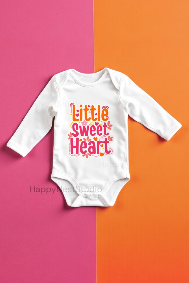 White long sleeve baby onesie featuring the colorful “Little Sweet Heart” Valentine design in pink, red, and orange tones, displayed flat on a bright pink and orange split background. it has smooth fabric with a permanent print that will not crack, peel, or fade. Perfect as an infant valentines onesie, first valentine onesie, boy valentines onesie, valentine onesie for baby girl, mamas valentine onesie, daddy’s valentine onesie, or our little valentine onesie.